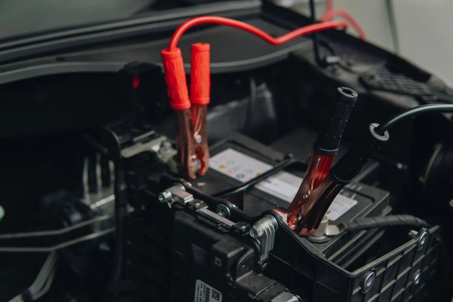 Booster cables attached to a battery when to call for a tow instead of jump-starting.